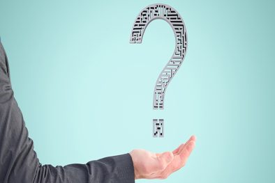 composite of hand holding questionmark graphic with blue background