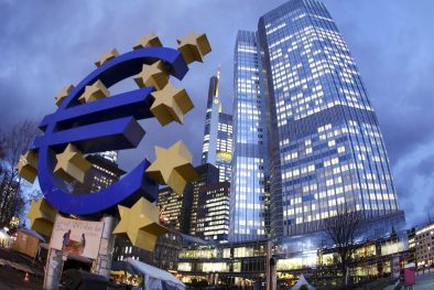 FILE - The Euro sculpture stands in front of the European Central Bank, right, in Frankfurt, Germany, in this Dec.16, 2011 file photo. The European Central Bank took bold steps Thursday June 5, 2014 to protect Europes fragile economic recovery, cutting interest rates and offering to pump more money into the financial system. (AP Photo/Michael Probst, File)